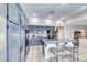 Beautiful kitchen with granite countertops, stainless steel appliances and blue painted cabinets at 3050 Whispering Crest Dr, Henderson, NV 89052