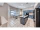 Bright kitchen featuring blue cabinets, stainless steel appliances, and an island with marble countertop at 3050 Whispering Crest Dr, Henderson, NV 89052