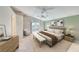 Spacious primary bedroom with bench, calming decor and balcony access at 3050 Whispering Crest Dr, Henderson, NV 89052