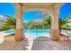 Inviting backyard pool featuring lush landscaping and a covered patio at 3050 Whispering Crest Dr, Henderson, NV 89052