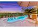 Backyard pool surrounded by lush landscaping, perfect for relaxing and entertaining at 3050 Whispering Crest Dr, Henderson, NV 89052