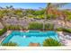 Refreshing pool area with mature landscaping and comfortable lounge seating at 3050 Whispering Crest Dr, Henderson, NV 89052