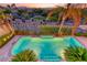 An inviting pool surrounded by lush landscaping, palm trees, and a charming neighborhood view at 3050 Whispering Crest Dr, Henderson, NV 89052