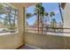 Balcony showcasing exterior views of nearby trees, a pool area, and the surrounding community at 3145 E Flamingo Rd # 2080, Las Vegas, NV 89121