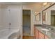 Bright bathroom featuring granite counters, a tub-shower, and updated fixtures at 3145 E Flamingo Rd # 2080, Las Vegas, NV 89121