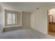 Bright bedroom featuring large window with bench seat, neutral carpet and ensuite bathroom access at 3145 E Flamingo Rd # 2080, Las Vegas, NV 89121