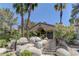 Exterior view of a clubhouse entrance, featuring rock landscaping and natural elements at 3145 E Flamingo Rd # 2080, Las Vegas, NV 89121