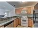 The kitchen showcases wood cabinets, granite countertops, modern appliances, and an open concept layout at 3145 E Flamingo Rd # 2080, Las Vegas, NV 89121