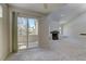 Living room with sliding glass doors that lead to a balcony, with a fireplace and neutral walls at 3145 E Flamingo Rd # 2080, Las Vegas, NV 89121