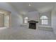 Spacious living room with a fireplace, large arched windows with bright neutral walls and carpet at 3145 E Flamingo Rd # 2080, Las Vegas, NV 89121