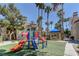 Community playground with slides and a play structure, surrounded by lush landscaping at 3145 E Flamingo Rd # 2080, Las Vegas, NV 89121