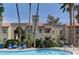 Community pool featuring lounge chairs and palm trees at a beautiful apartment complex at 3145 E Flamingo Rd # 2080, Las Vegas, NV 89121