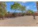 Spacious backyard featuring desert landscaping and a charming bird bath, enclosed with a brick wall for privacy at 3521 Amish Ave, North Las Vegas, NV 89031