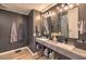 Contemporary bathroom featuring dual sinks, modern fixtures, and dark gray accent walls at 353 E Bonneville Ave # 379, Las Vegas, NV 89101