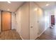 Hallway with wooden floors, white walls, and multiple doors, providing safety and access at 353 E Bonneville Ave # 379, Las Vegas, NV 89101