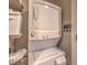 Laundry room with stacked white washer and dryer next to shelf for storage at 353 E Bonneville Ave # 379, Las Vegas, NV 89101