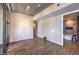 Living room with wood floors, modern lighting, and a bright window leading to the bath area at 353 E Bonneville Ave # 379, Las Vegas, NV 89101