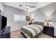 Cozy bedroom features a queen bed, ceiling fan and natural light from a window at 4020 Driscoll Mountain St, Las Vegas, NV 89129