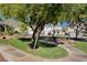Beautifully landscaped common area with mature trees, park bench and manicured lawns at 4020 Driscoll Mountain St, Las Vegas, NV 89129