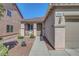 Inviting home entrance featuring a covered porch with seating and well-kept landscaping at 4020 Driscoll Mountain St, Las Vegas, NV 89129