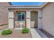 Close-up of the entrance with a seating area, security screen door, and neat landscaping at 4020 Driscoll Mountain St, Las Vegas, NV 89129