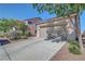 Exterior of the home showing the two-car garage, mature trees, and a well-maintained yard at 4020 Driscoll Mountain St, Las Vegas, NV 89129