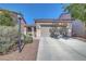 Charming home exterior features a two-car garage, low-maintenance landscaping, and a welcoming entrance at 4020 Driscoll Mountain St, Las Vegas, NV 89129