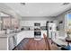 Bright kitchen features white cabinets, stainless steel appliances, and a dining area with backyard views at 4020 Driscoll Mountain St, Las Vegas, NV 89129