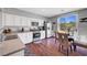 Modern kitchen with stainless appliances, granite countertops and a dining area with a view of the pool at 4020 Driscoll Mountain St, Las Vegas, NV 89129