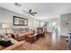 Spacious living room featuring wood floors, neutral paint, ceiling fan, and comfortable seating at 4020 Driscoll Mountain St, Las Vegas, NV 89129
