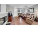Inviting living room with hardwood floors, plush seating, ceiling fan and a cozy fireplace at 4020 Driscoll Mountain St, Las Vegas, NV 89129