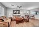 Bright living room with wood floors, a ceiling fan, and an open layout to the kitchen at 4020 Driscoll Mountain St, Las Vegas, NV 89129