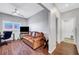 Cozy living room with a leather couch, desk area, and modern flooring at 4020 Driscoll Mountain St, Las Vegas, NV 89129