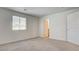 This bedroom features neutral carpet, a window, and a closet door at 4229 Venus Falls Ave, North Las Vegas, NV 89084