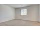 This bedroom features neutral carpet, a window, and neutral walls at 4229 Venus Falls Ave, North Las Vegas, NV 89084