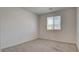 This bedroom features neutral carpet and a window for natural light at 4229 Venus Falls Ave, North Las Vegas, NV 89084