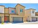 Attractive townhome with a front-entry garage and modern design elements at 4229 Venus Falls Ave, North Las Vegas, NV 89084