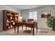 Virtually staged home office with desk, shelves, and decor at 4229 Venus Falls Ave, North Las Vegas, NV 89084