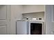This laundry room features modern side-by-side washer and dryer units at 4229 Venus Falls Ave, North Las Vegas, NV 89084