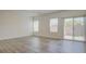 Bright, empty living room with a sliding glass door to the backyard at 4229 Venus Falls Ave, North Las Vegas, NV 89084