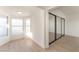 Bright bedroom features lots of natural light, wood-look floors, and a mirrored closet at 4301 Fortune Ave, Las Vegas, NV 89107
