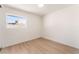 Clean bedroom features wood-look floors, a window, and white walls at 4301 Fortune Ave, Las Vegas, NV 89107