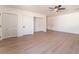 Bright bedroom with wood floors, a ceiling fan, and ample closet space at 4301 Fortune Ave, Las Vegas, NV 89107