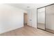 Clean and bright bedroom features a large mirror closet and wood-look floors at 4301 Fortune Ave, Las Vegas, NV 89107