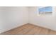 Simple bedroom features a window, white walls and wood-look floors at 4301 Fortune Ave, Las Vegas, NV 89107