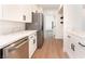 Charming kitchen with stainless steel appliances, light wood flooring, and white countertops at 4301 Fortune Ave, Las Vegas, NV 89107