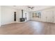 Spacious living room with wood flooring, a decorative fireplace, and natural light from large windows at 4301 Fortune Ave, Las Vegas, NV 89107