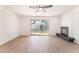Bright living room with wood floors, fireplace, and large sliding glass door with pool view at 4301 Fortune Ave, Las Vegas, NV 89107