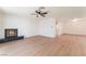 Open-concept living room featuring wood floors, modern lighting, and a decorative fireplace at 4301 Fortune Ave, Las Vegas, NV 89107