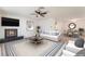 Bright living room with fireplace, ceiling fan, neutral color palette, and adjacent dining area at 4301 Fortune Ave, Las Vegas, NV 89107